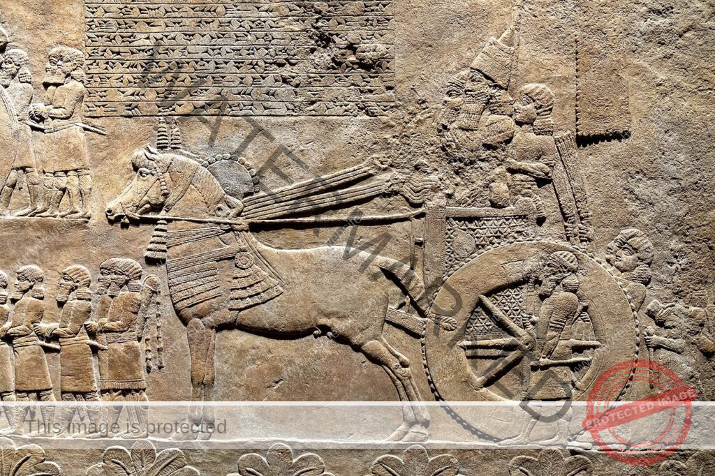 Ashurbanipal in a chariot inspecting booty and prisoners from Babylon